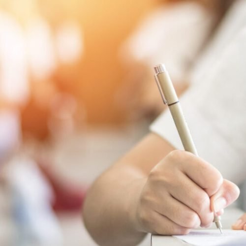 Exam with school student having a educational test, thinking hard, writing answer in classroom for  university education admission and world literacy day concept